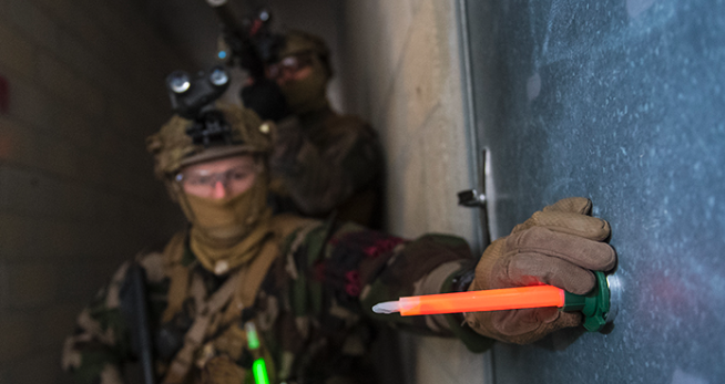 Man marking a vehicle with a chemical light