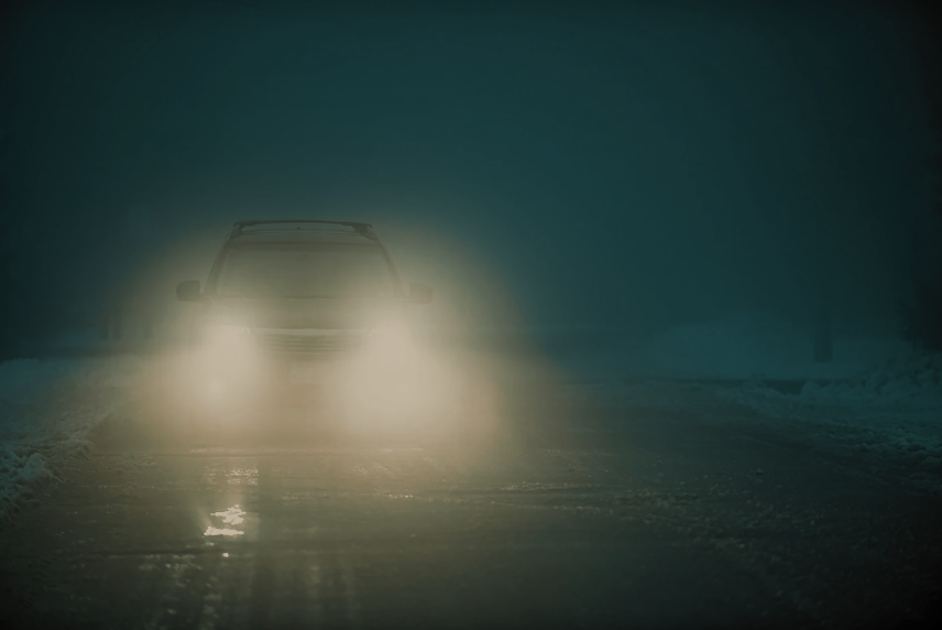 Vehicle with dim headlights in the dark