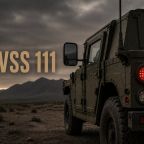 FMVSS 111 military vehicle with rear lights and side mirror in rugged terrain.